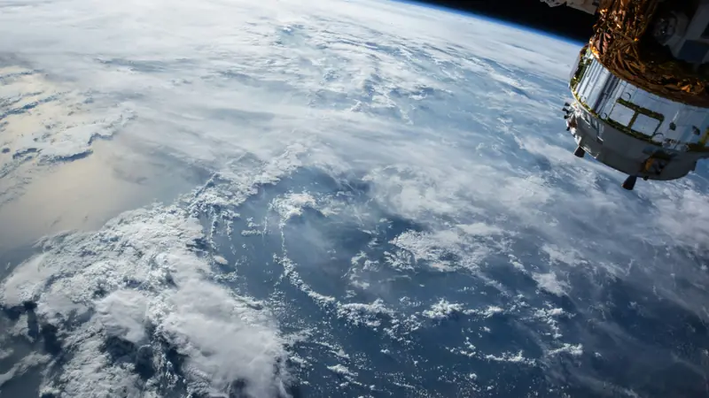 Earth's curved horizon and a swirling storm system seen from orbit.