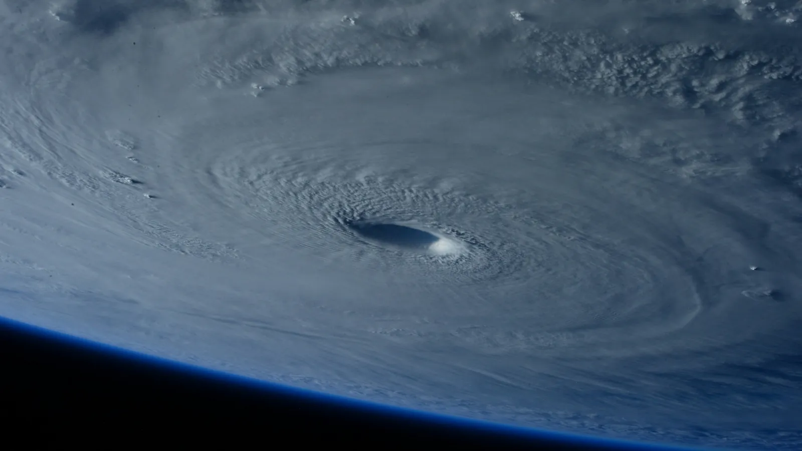 A hurricane's eye and spiral cloud bands photographed from space.